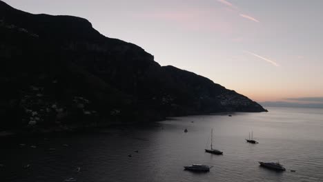 Tranquil-View-Of-Luxury-Yachts-Floating-During-Dusk-In-The-Mediterranean-Sea-Near-Positano,-Campania,-Italy
