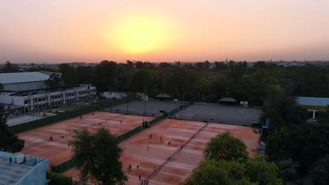 4K-Drone-Shots-of-a-Sunset-in-an-Indian-City-New-Delhi-above-trees-and-houses-beautiful-light-punjabi-bagh-club-posh-colony