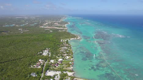 Aerial-view-overlooking-the-paradise-shoreline-of-Punta-Cana,-sunny-Dominican-republic---circling,-drone-shot