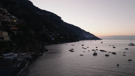 Silhouettes-On-Positano-Village-With-Sailboats-At-Sunset-On-Amalfi-Coast-In-Campania,-Italy