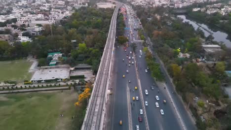 4K-Drone-Shots-of-a-Sunset-in-an-Indian-City-New-Delhi-above-trees-and-houses-beautiful-light-punjabi-bagh-club-posh-colony-Metro-train