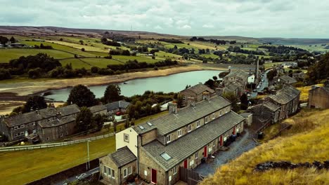Aerial-drone-footage-of-a-rural-industrial-Yorkshire-Village-town-with-old-mill-chimney