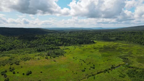 A-beautiful-drone-shot-of-the-mountainous-plains-in-New-England-with-a-couple-patches-of-marshland