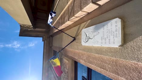 Memorial-facade-plaque-under-flags-of-Moldova-and-European-union