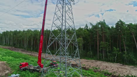 Workers-working-at-high-voltage-power-line-in-rural-landscape