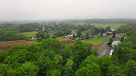 A-drone-shot-of-a-country-side-area-with-a-plowed-field