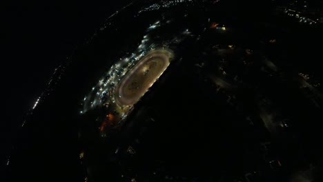 Aerial-asteroid-shot-of-oval-dirt-track-racing-at-night