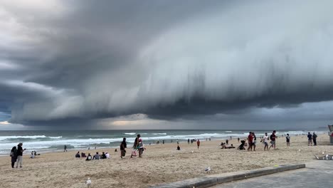 Ominous-dark-and-thick-layer-of-clouds-covering-the-sky-at-the-beach-of-surfers-paradise,-wet-and-wild-storm-season-approaching-this-summer,-Gold-Coast,-Queensland,-Australia