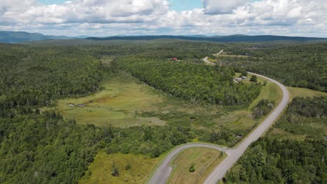 An-aerial-shot-of-a-swampy-area-with-a-road-cutting-through-the-area