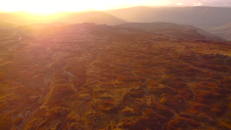 Aerial-flyover-beautiful-landscape-with-moor-and-heather-at-Kinder-Scout-Mountain-in-England-at-sunset