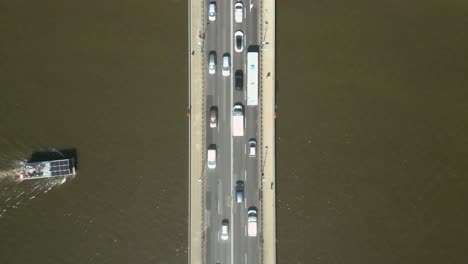 Zoom-out-from-the-bird's-eye-view-over-the-bridge-under-which-the-boat-is-sailing