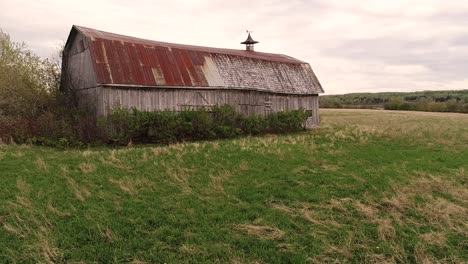 A-very-old-barn-surrounded-by-farm-fields