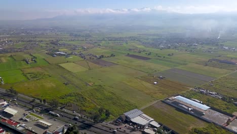 Aerial-view-of-agriculture-fields-close-to-Mexico-City,-and-around-the-volcanoes