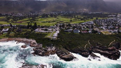 Drone-view-over-ocean-of-stunning-Hermanus-coastline-and-lovely-golf-course