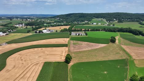 An-aerial-view-over-the-lush-green-farmland-in-southern-Lancaster-County,-Pennsylvania-on-a-sunny-summer-day