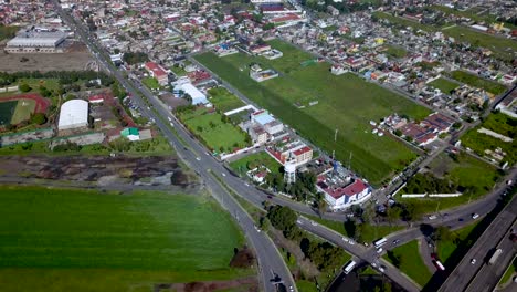 Top-drone-view-of-an-interchange-on-a-small-highway-in-the-charming-town-of-chalco-Mexico,-a-the-density