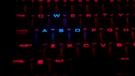 Backlit-illuminated-keyboard-in-red-whit-the-wasd-keys-in-blue-for-a-perfect-gaming-experience-whit-a-breathing-pattern-zoom-in
