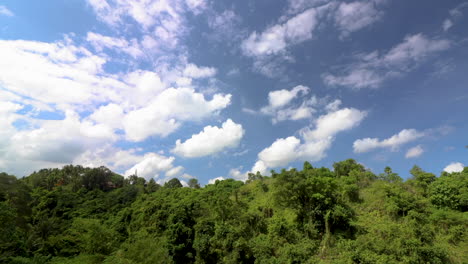 Wide-Angle-timelapse-of-blue-sky-and-white-clouds-of-lush-green-jungle-vegetation