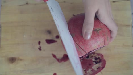 Making-lateral-cuts-with-the-knife-on-pomegranate-to-easily-open-it