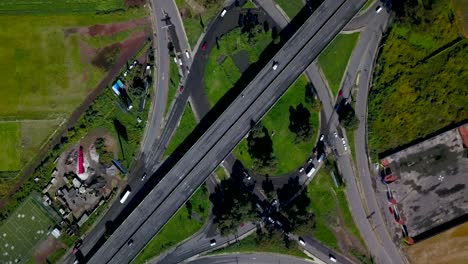 Top-drone-view-of-a-cloverleaf-interchange-on-a-small-highway-in-the-charming-town-of-chalco-Mexico