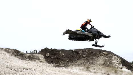 A-guy-is-jumping-very-high-with-his-snowmobile-during-a-race