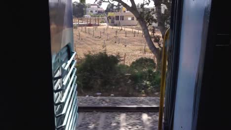 Looking-out-the-train-door,-south-India