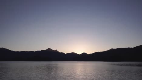 Sunset-over-Long-Arm-inlet,-mountains,-Queen-Charlotte,-Haida-Gwaii