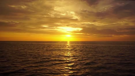Tropical-sunset-cruise,-panning-sunset-over-the-ocean,-Malaysia