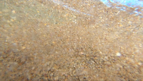 POV-from-within-the-surf-being-buffeted-around-within-the-waves-surrounded-by-sand-and-bubbles-and-wave-froth