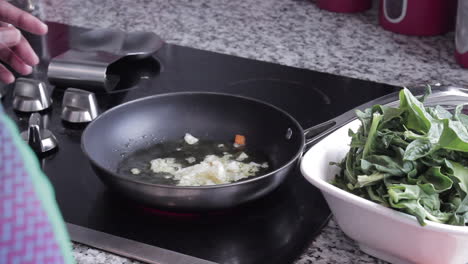 Woman-making-sauteed-spinach-on-stove
