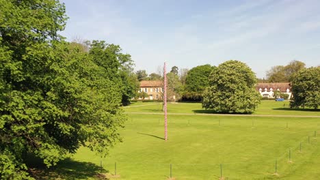 Flying-out-from-a-Maypole-on-a-village-green-on-a-summer-day