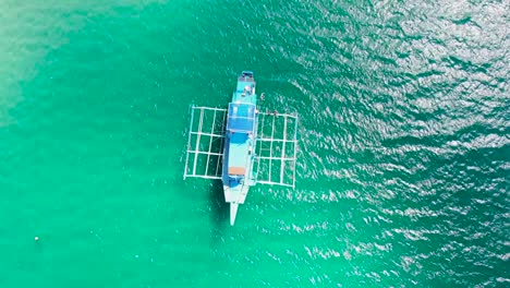 Boat-in-crystal-blue-water-from-above