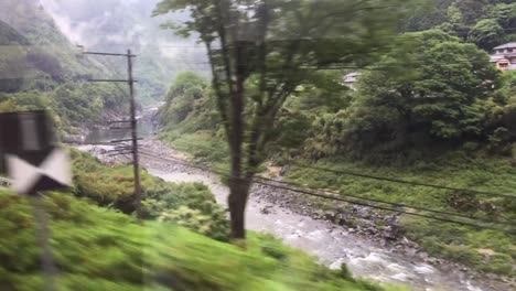 Japanese-mountain-train-moves-along-the-course-of-the-river