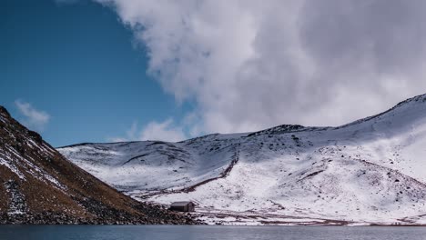 View-of-the-main-lagoon-in-Nevado-de-Toluca-volcano,-in-a-time-lapse-showing-the-many-tourist-attracted-to-the-location-after-a-snowfall-which-rarely-occurs-in-Mexico