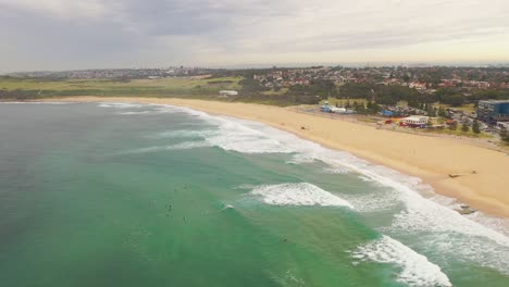 Panning-from-above-from-surfers-waiting-for-a-wave-to-the-beach