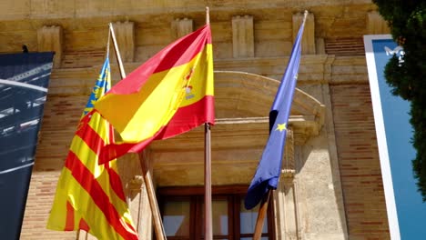 Close-up-shot-of-Valencian,-Spanish-and-European-flags-together