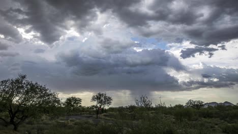 Monsoon-clouds-march-across-a-desert-landscape-dropping-rain-in-the-distance