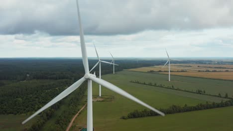 Aerial-close-up-of-a-wind-turbine-park-in-the-background