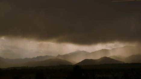 Timelapse-of-mountains-with-transition-from-a-sunny-city-to-a-rain-storm-4K