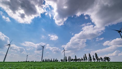 Blue-skies-and-white-fluffy-clouds-above-the-green-fields-and-wind-turbines-somewhere-in-Germany