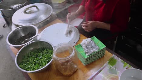 slow-motion-video-of-the-whole-process-of-making-banh-cuon---vietnamese-steamed-rice-rolls-and-the-resulting-with-a-prepared-dish-on-the-table