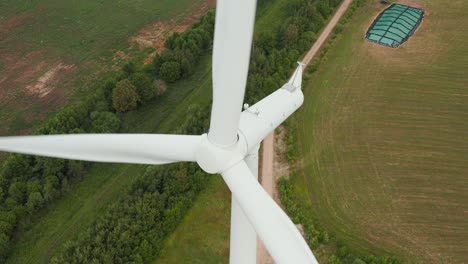Aerial-top-down,-downward-view-of-a-rotating-wind-turbine