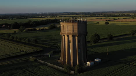 Aerial-footage-of-a-water-tower-on-a-summers-evening