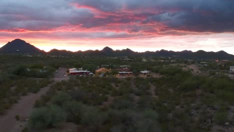 An-aerial-view-of-a-vibrant-Tucson,-AZ-sunset-that-slowly-pulls-back