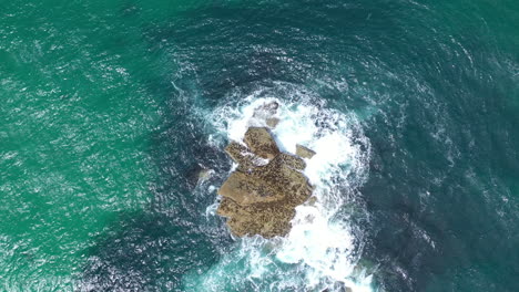 Aerial-drone-view-of-a-rock-in-the-sea-in-st-ives-Cornwall