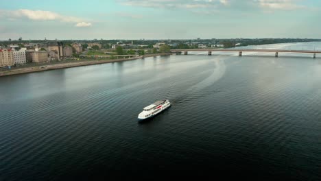 Aerial-video-of-a-cruise-ship-on-a-river-in-Riga-city-center