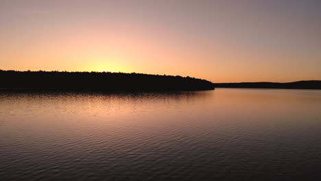 Beautiful-morning-sunrise-over-calm-lake