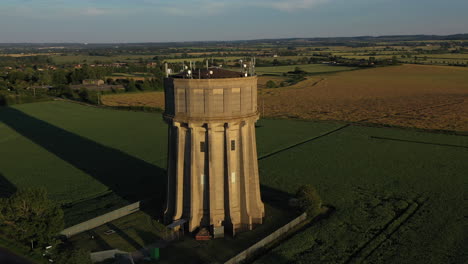Aerial-footage-of-a-water-tower-on-a-summers-evening