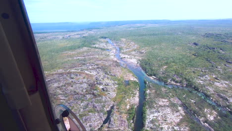 Light-aircraft-flying-towards-river-valley-Kakadu-National-Park-Northern-Territory-Australia