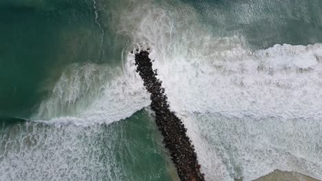 View-from-above-of-crashing-waves-against-the-Noosa-wave-breaker
